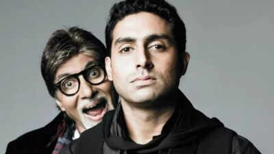 Amitabh Bachchan deeply engaged in a conversation with his son Abhishek during a studio session.