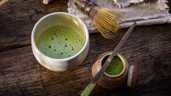 Close-up of matcha powder being whisked in a bowl