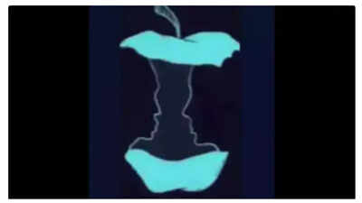 A visual illusion featuring an apple core and two faces